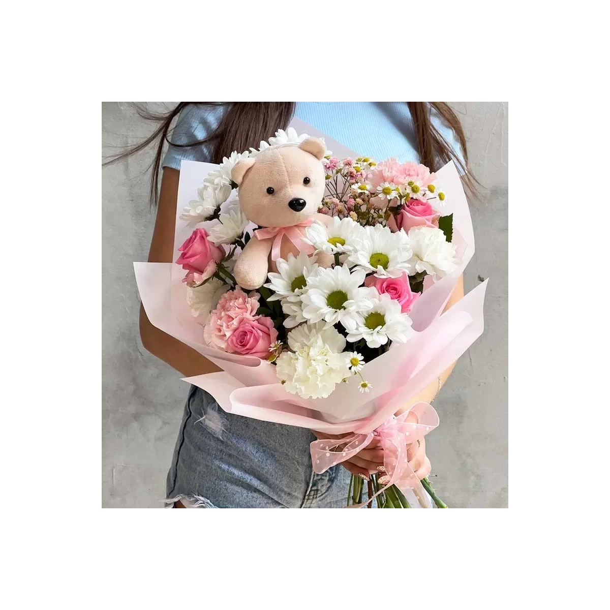 Bouquet of flowers and teddy bear