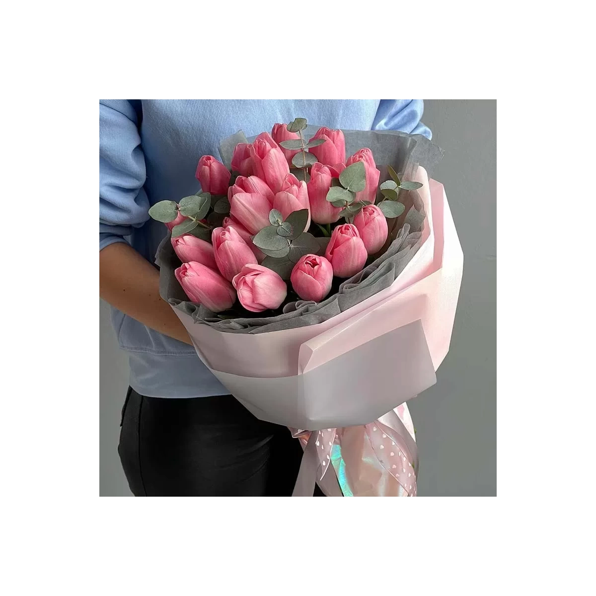 A bouquet of pink tulips in a stylish wrapping photo