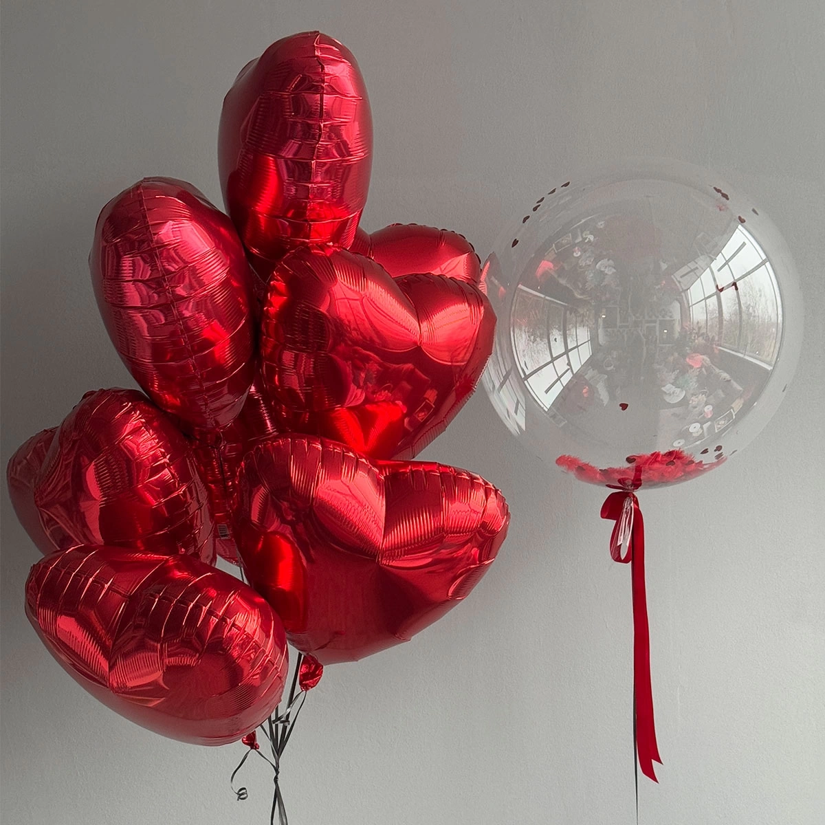 Helium heart balloons with a bubble and heart-shaped confetti photo