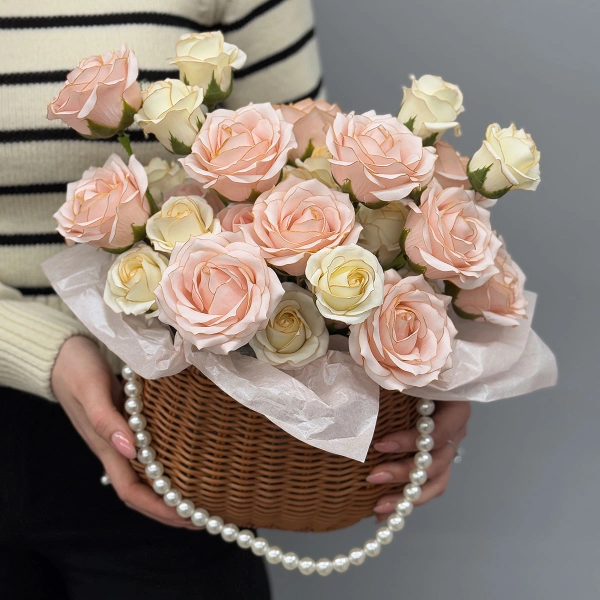 A bouquet of soap roses in a basket in delicate colors photo