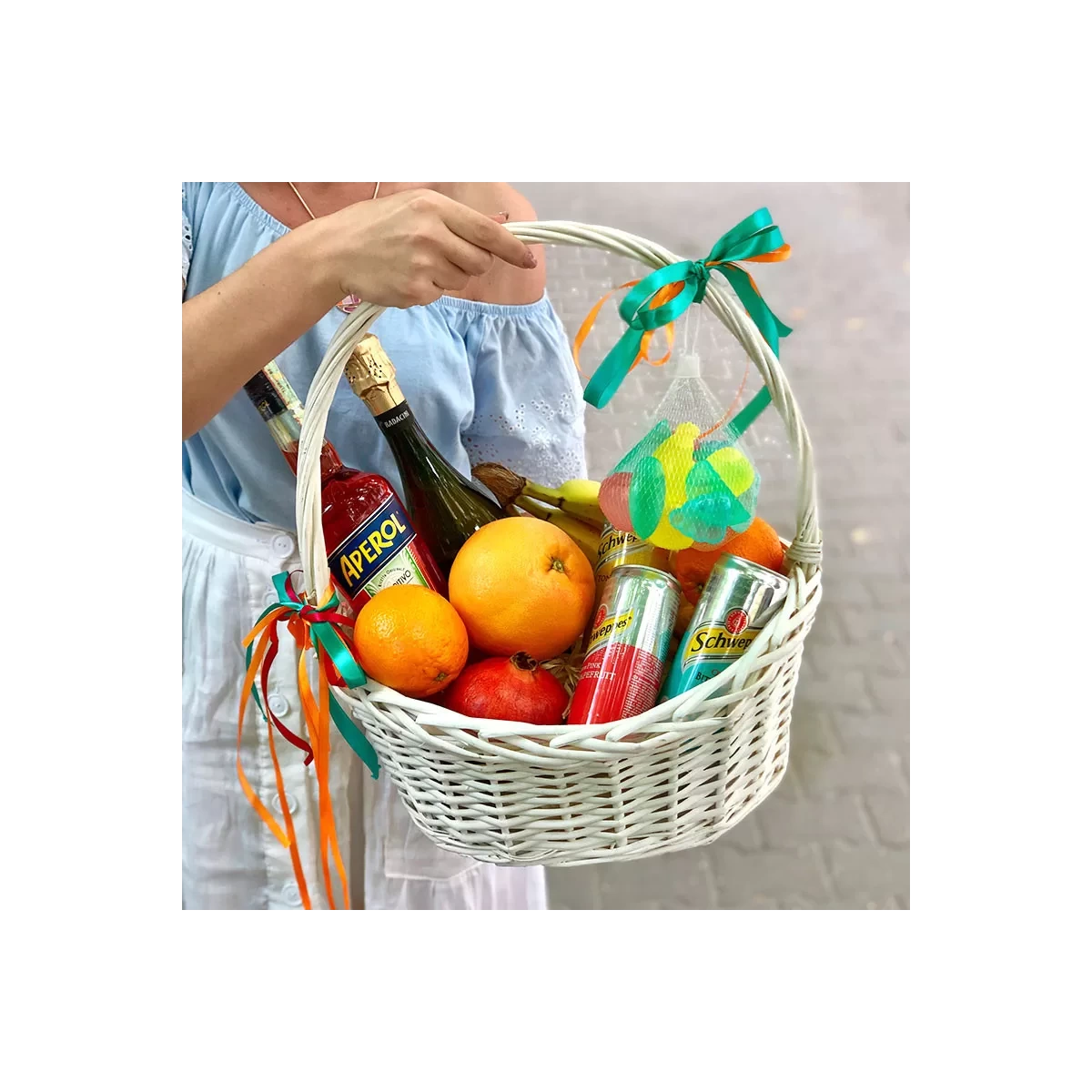 Basket with alcohol and fruit photo